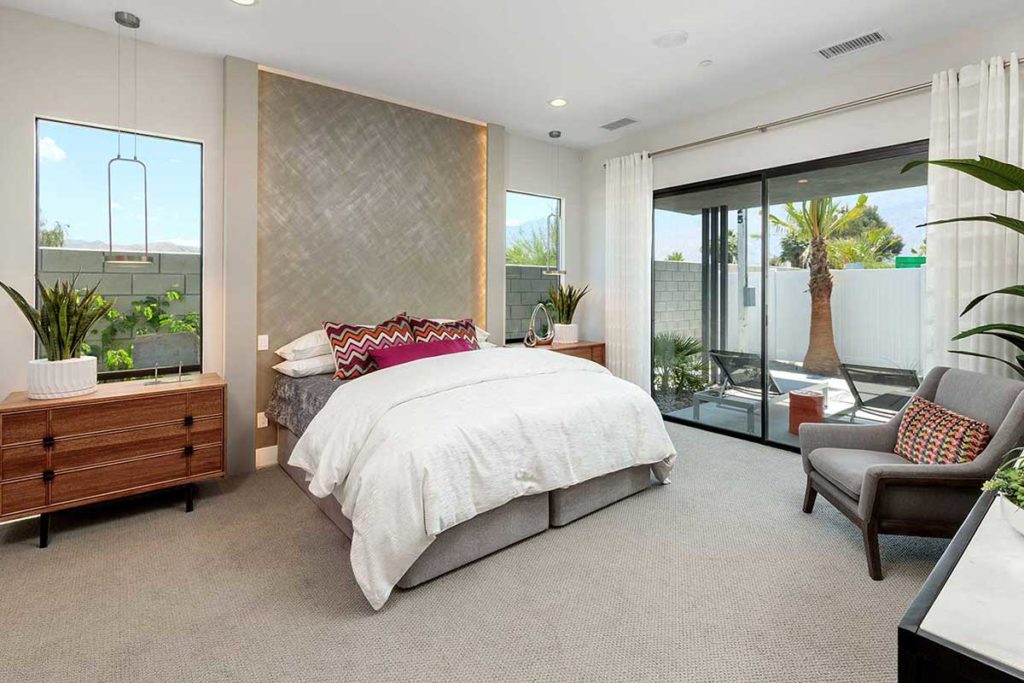 Master bedroom with Palm Springs vibe designed by interior design firm Design Tec, Inc. In collaborating with GHA Properties. Photography by Mark Davidson Photography.